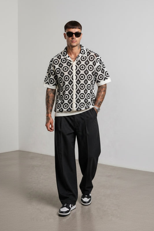Modello indossa camicia GetOneStore-civitavecchia a maniche corte in crochet bianco e nero con motivo geometrico