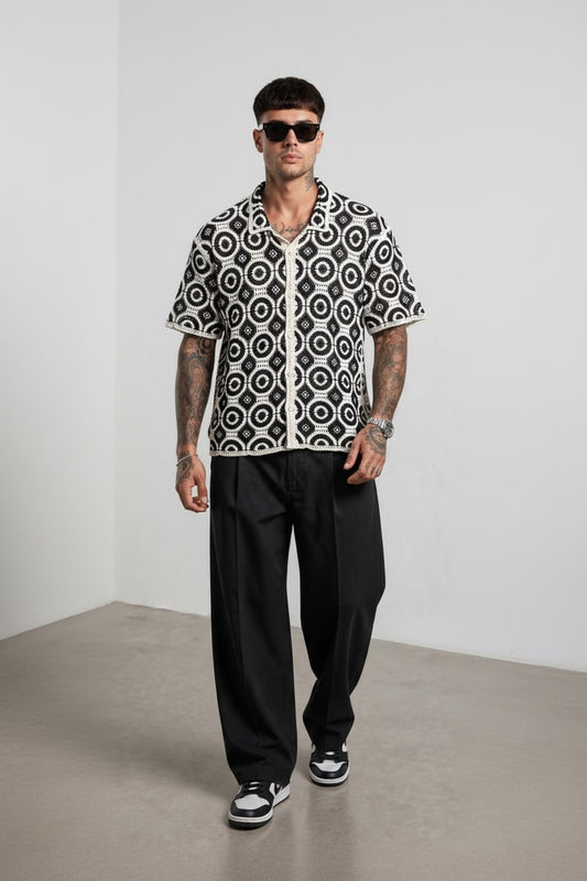 Modello indossa camicia GetOneStore-civitavecchia a maniche corte in crochet bianco e nero con motivo geometrico